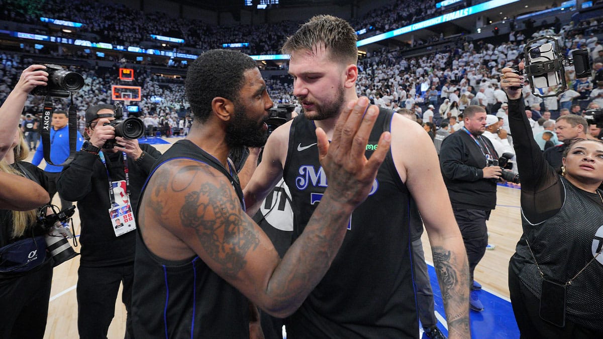 Minneapolis, Minnesota, USA; Dallas Mavericks guard Kyrie Irving (11) and guard Luka Doncic (77) celebrate after defeating the Minnesota Timberwolves in game two of the western conference finals for the 2024 NBA playoffs at Target Center. Mandatory 
