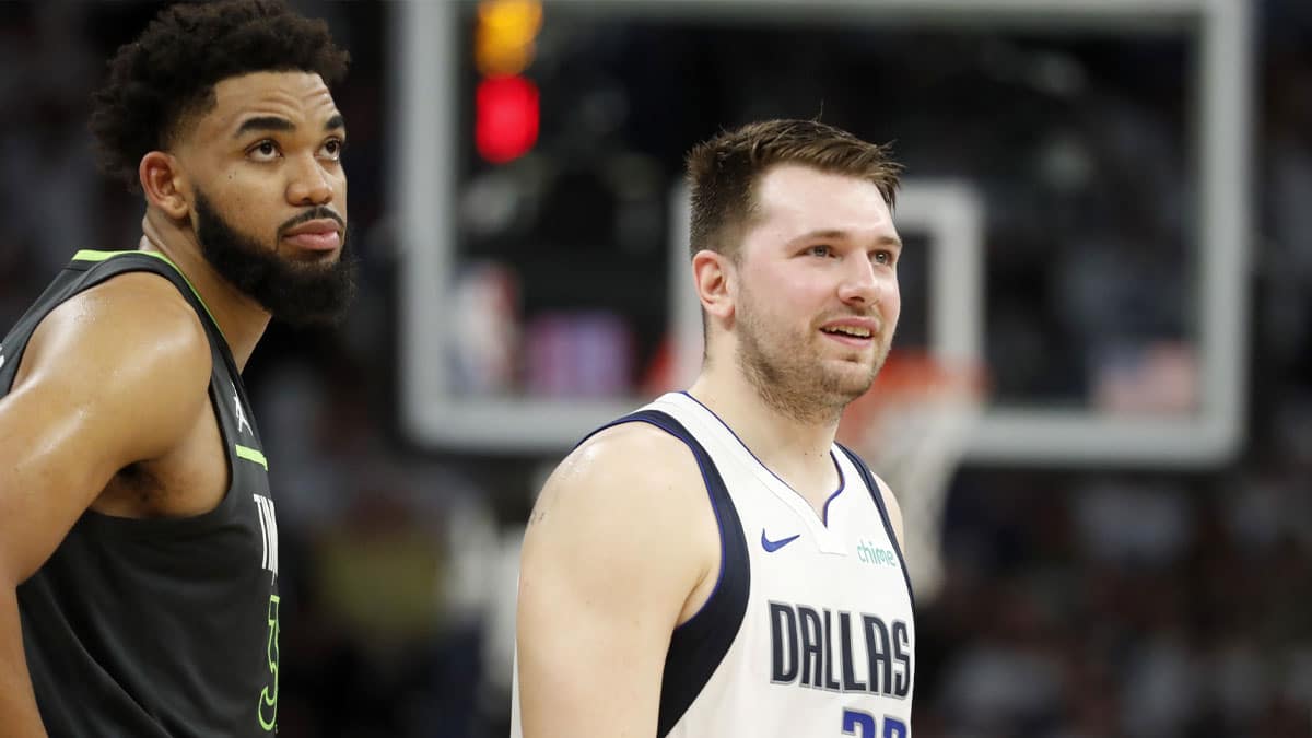 Minnesota Timberwolves center Karl-Anthony Towns (32) and Dallas Mavericks guard Luka Doncic (77) during the second quarter in game five of the western conference finals for the 2024 NBA playoffs at Target Center. 
