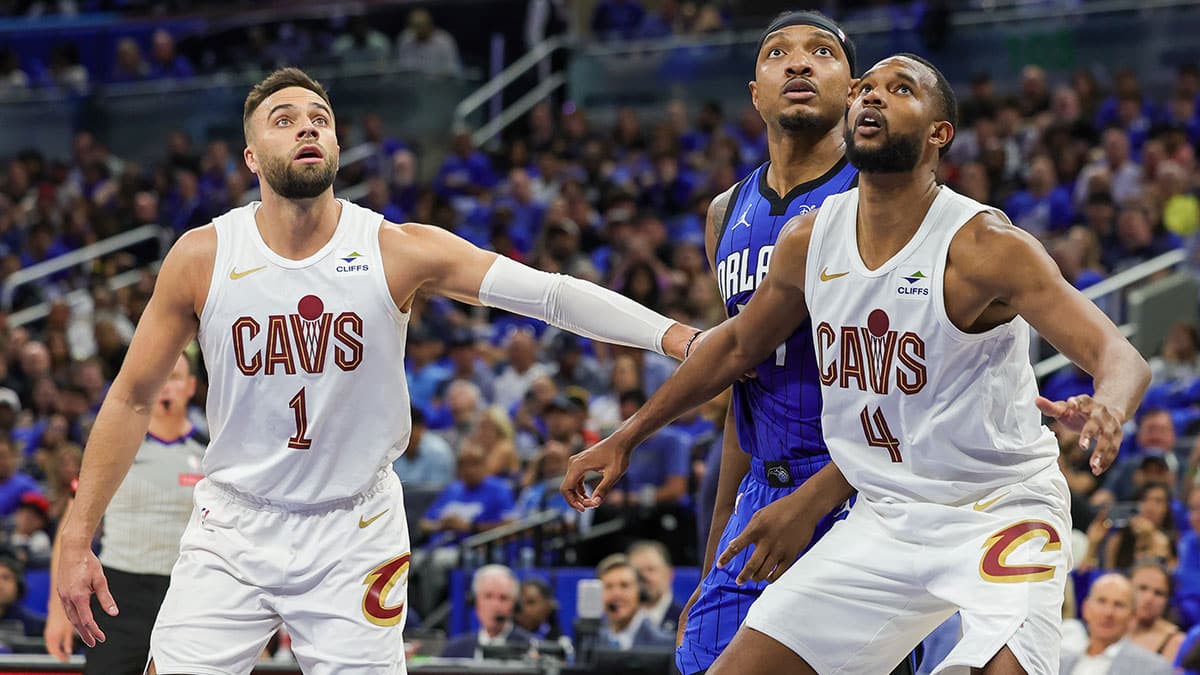 Cleveland Cavaliers guard Max Strus (1) forward Evan Mobley (4) and Orlando Magic center Wendell Carter Jr. (34) look for the rebound during the second quarter of game six of the first round for the 2024 NBA playoffs at Kia Center.