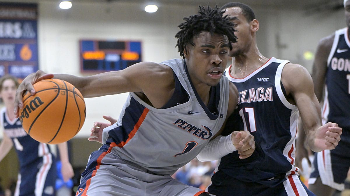 Pepperdine Waves guard Michael Ajayi (1) is defended by Gonzaga Bulldogs guard Nolan Hickman (11) in the second half at Firestone Fieldhouse.