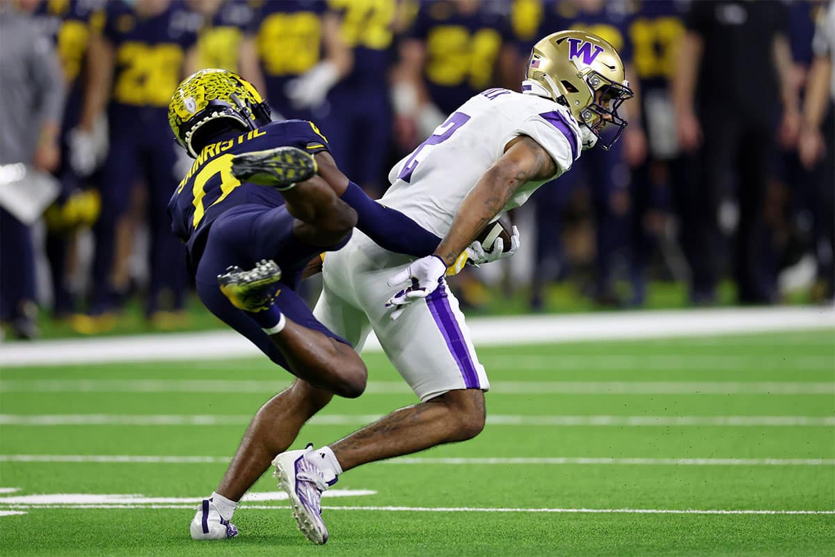 Michigan Wolverines defensive back Mike Sainristil (0) attempts to tackle Washington Huskies wide receiver Ja'Lynn Polk (2) during the fourth quarter in the 2024 College Football Playoff national championship 