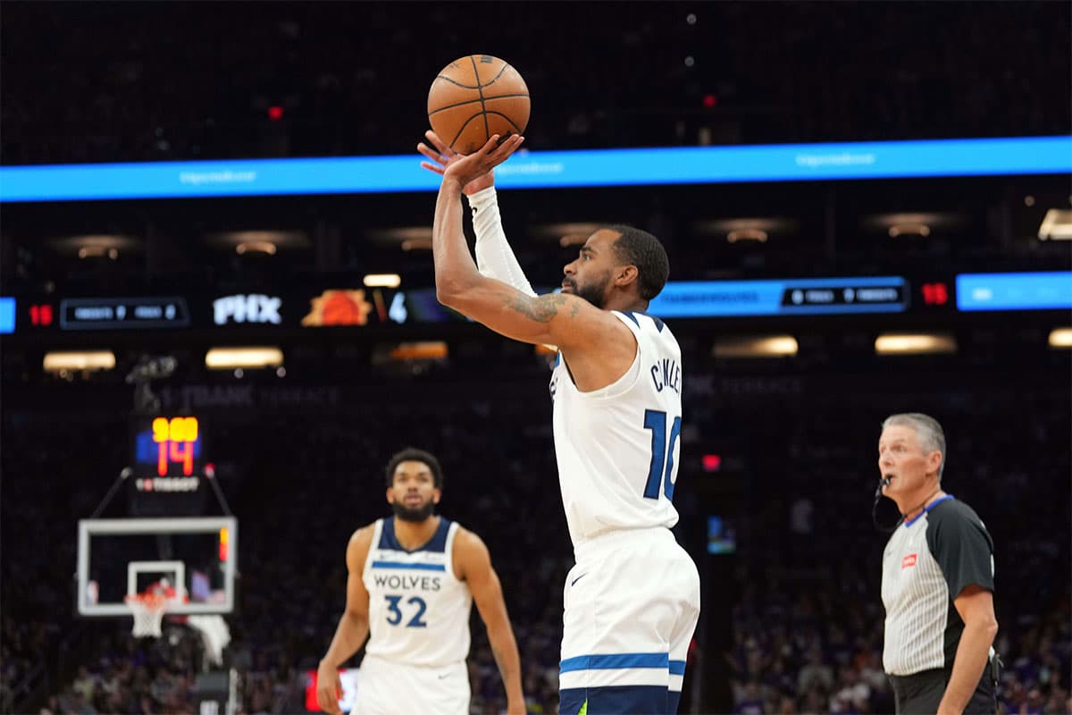 Minnesota Timberwolves guard Mike Conley (10) shoots against the Phoenix Suns during the first half of game four of the first round for the 2024 NBA playoffs at Footprint Center. 