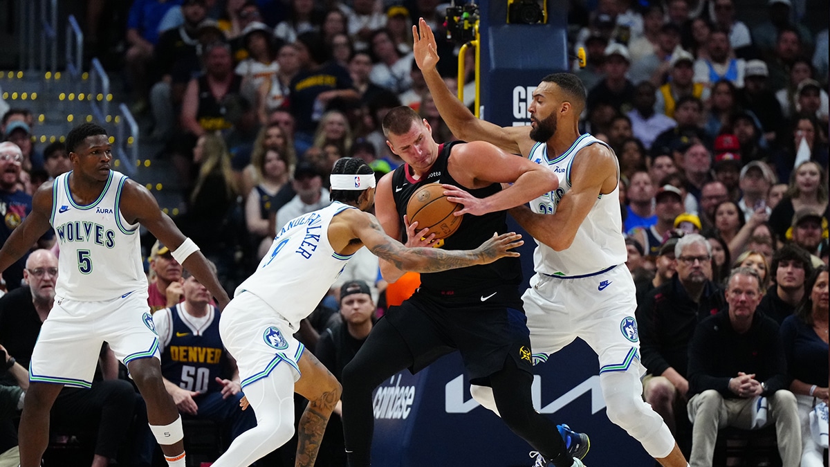 May 19, 2024; Denver, Colorado, USA; Minnesota Timberwolves center Rudy Gobert (27) and guard Nickeil Alexander-Walker (9) defend Denver Nuggets center Nikola Jokic (15) in the first half in game seven of the second round for the 2024 NBA playoffs at Ball Arena. Mandatory Credit: Ron Chenoy-USA TODAY Sports