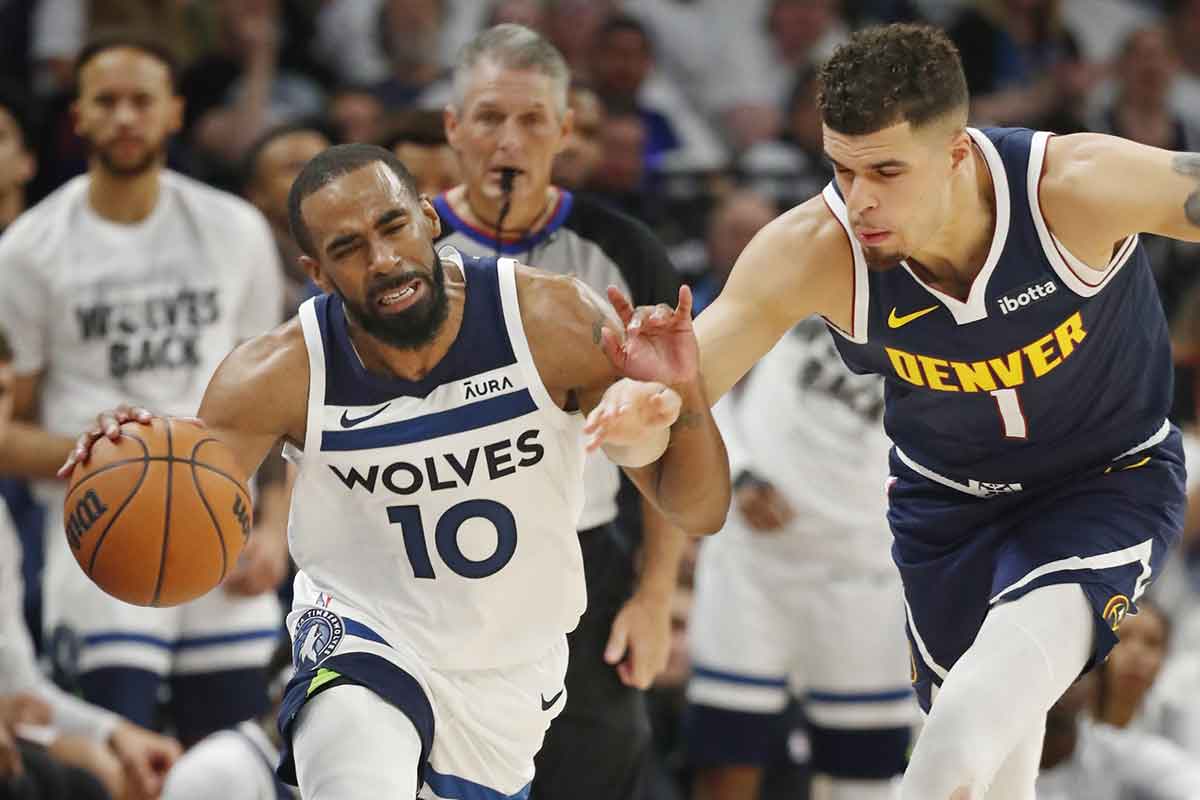 May 12, 2024; Minneapolis, Minnesota, USA; Minnesota Timberwolves guard Mike Conley (10) dribbles up court as Denver Nuggets forward Michael Porter Jr. (1) defends him in the fourth quarter of game four of the second round for the 2024 NBA playoffs at Target Center. Mandatory Credit: Bruce Kluckhohn-USA TODAY Sports