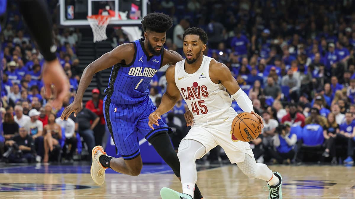 Cleveland Cavaliers guard Donovan Mitchell (45) drives to the basket against Orlando Magic forward Jonathan Isaac (1) during the first quarter of game six of the first round for the 2024 NBA playoffs at Kia Center.