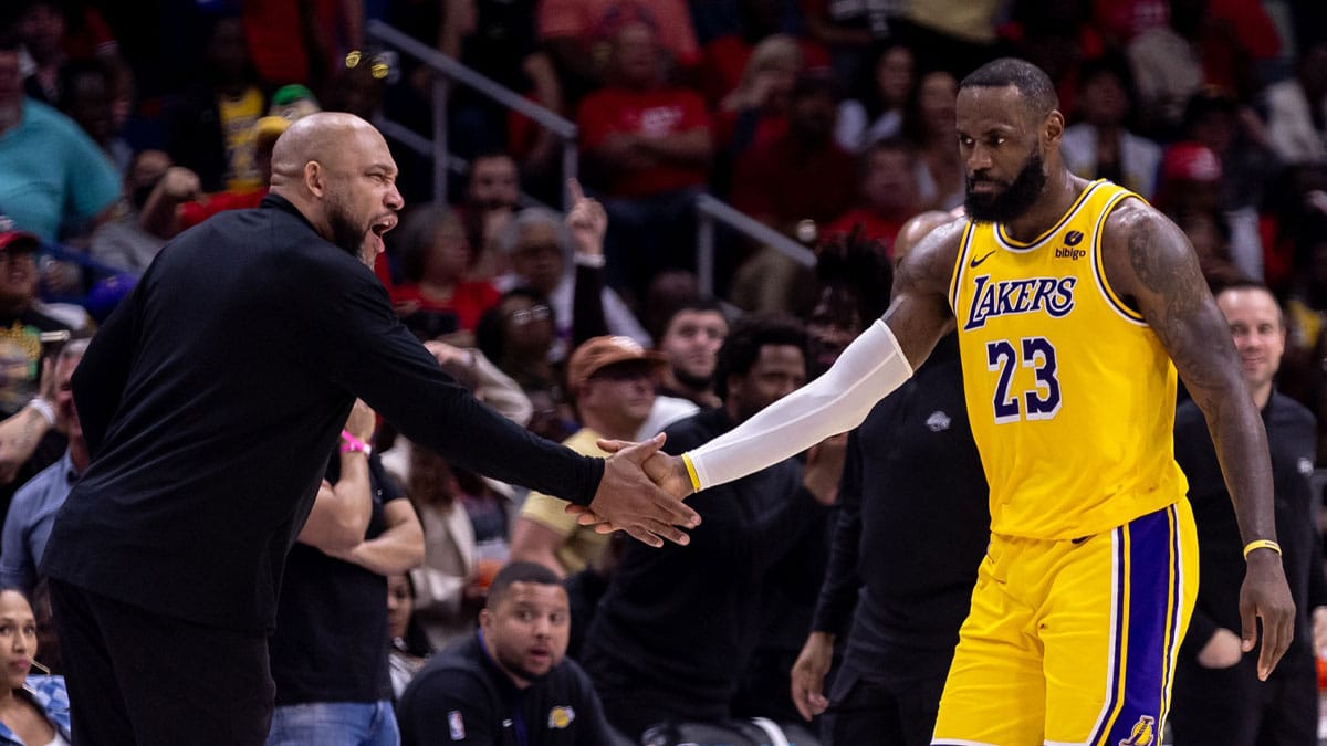 Los Angeles Lakers forward LeBron James (23) reacts after a play with head coach Darvin Ham
