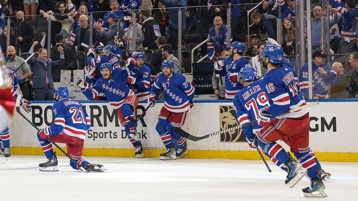 New York Rangers center Barclay Goodrow (21) celebrates his game-winning overtime goal with teammates in game two of the Eastern Conference Final of the 2024 Stanley Cup Playoffs against the Florida Panthers at Madison Square Garden.