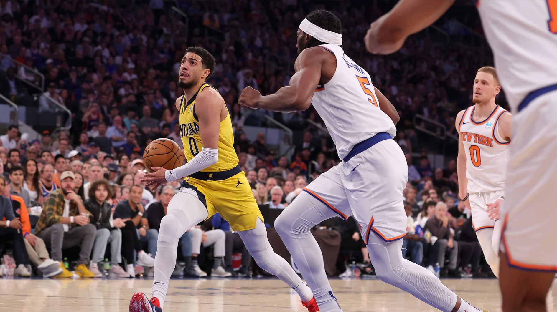 May 19, 2024; New York, New York, USA; Indiana Pacers guard Tyrese Haliburton (0) drives to the basket against New York Knicks forward Precious Achiuwa (5) and guard Donte DiVincenzo (0) during the second quarter of game seven of the second round of the 2024 NBA playoffs at Madison Square Garden. Mandatory Credit: Brad Penner-USA TODAY Sports
