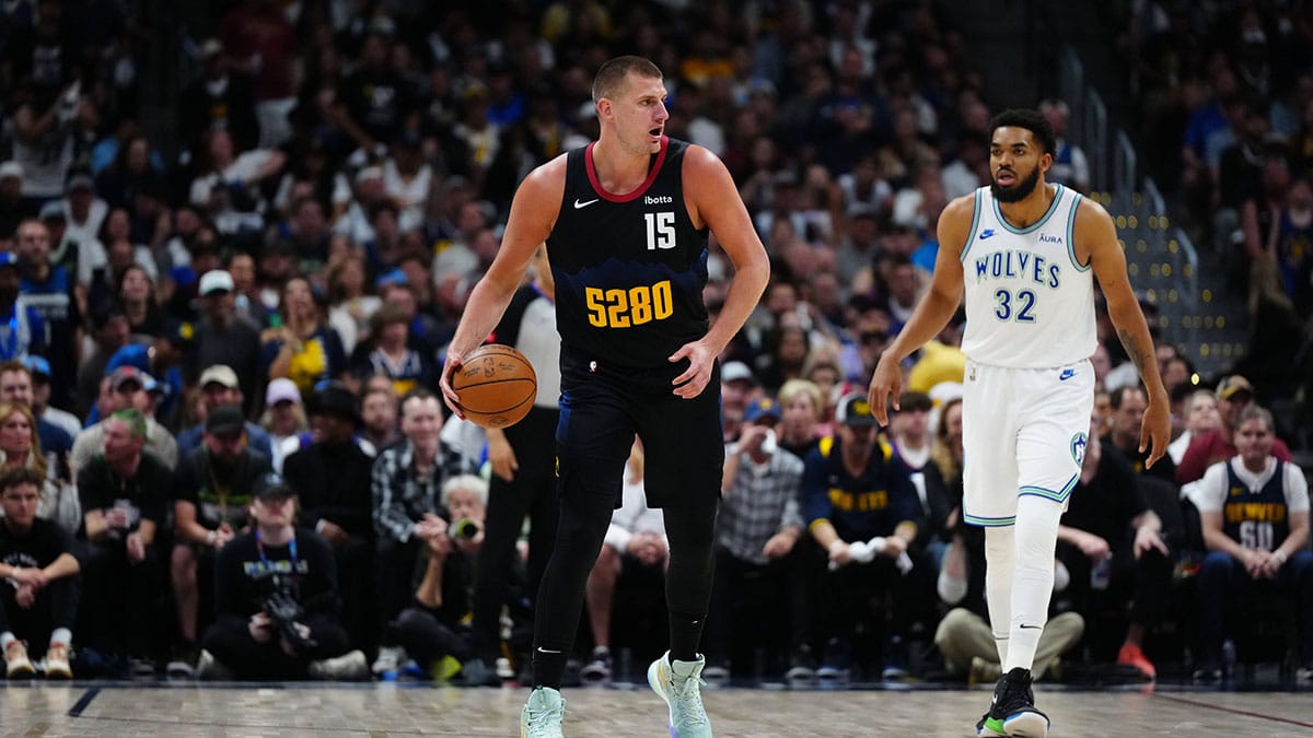 Denver Nuggets center Nikola Jokic (15) and Minnesota Timberwolves center Karl-Anthony Towns (32) in the first quarter in game seven of the second round for the 2024 NBA playoffs at Ball Arena.