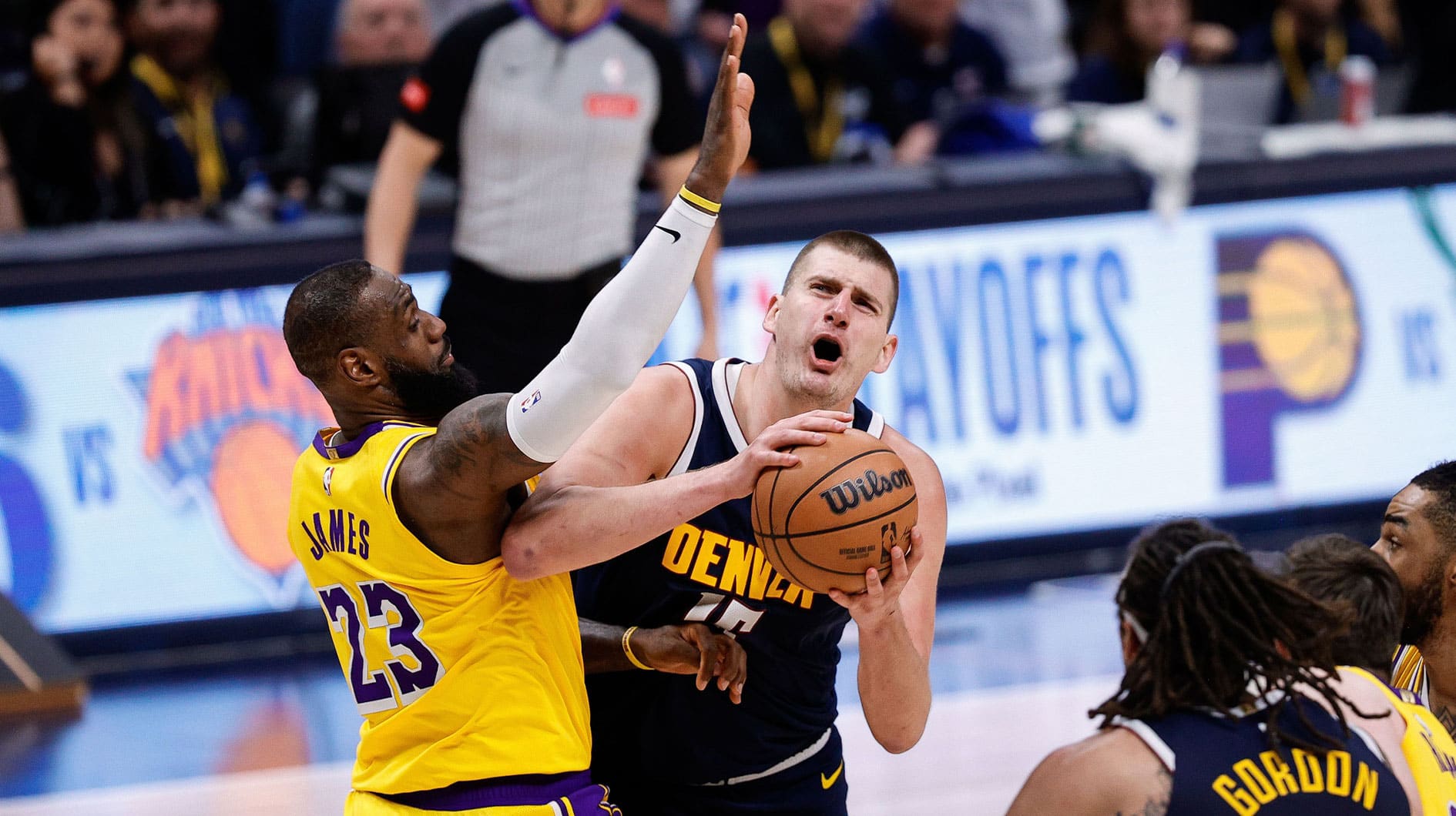 Denver Nuggets center Nikola Jokic (15) drives to the net against Los Angeles Lakers forward LeBron James (23) in the fourth quarter during game five of the first round for the 2024 NBA playoffs at Ball Arena.