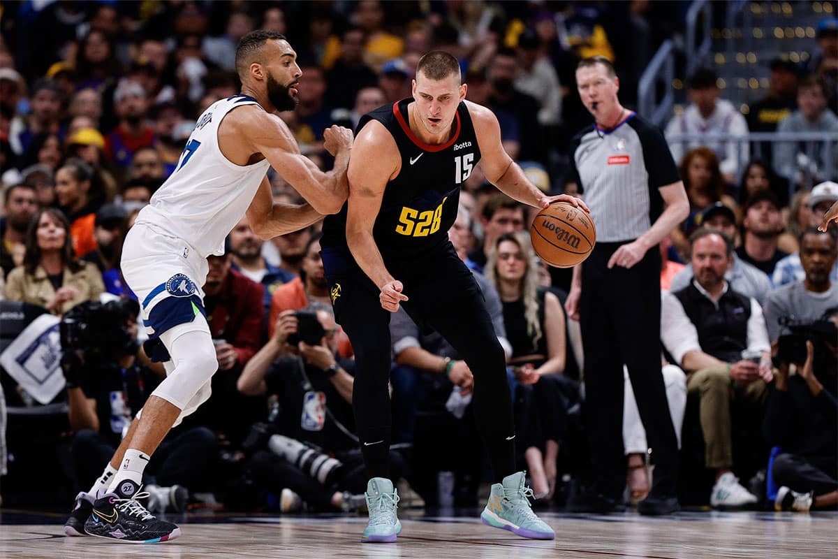 Denver Nuggets center Nikola Jokic (15) controls the ball as Minnesota Timberwolves center Rudy Gobert (27) guards in the first quarter during game five of the second round for the 2024 NBA playoffs at Ball Arena.