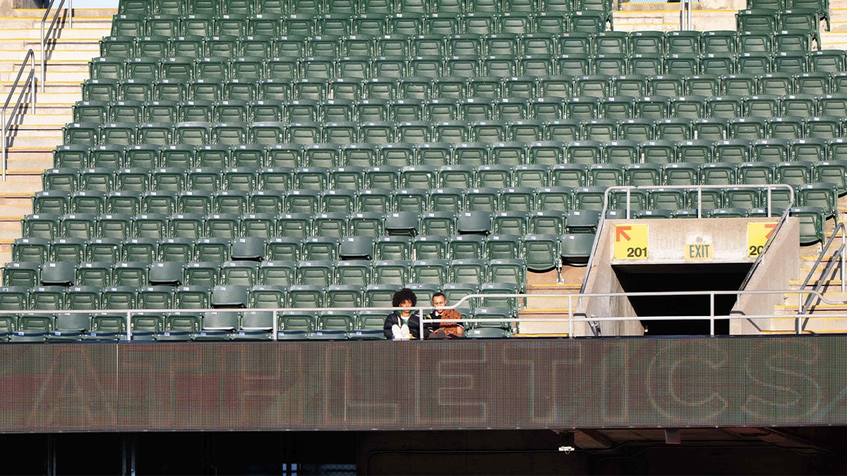Oakland Athletics fans sit amongst an empty section during the third inning against the Arizona Diamondbacks at Oakland-Alameda County Coliseum.