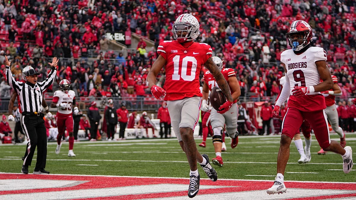 Ohio State Buckeyes wide receiver Xavier Johnson (10) scores a touchdown past Indiana Hoosiers defensive back Brylan Lanier (9) on a 71-yard run during the second half of the NCAA football game at Ohio Stadium. Ohio State won 56-14.