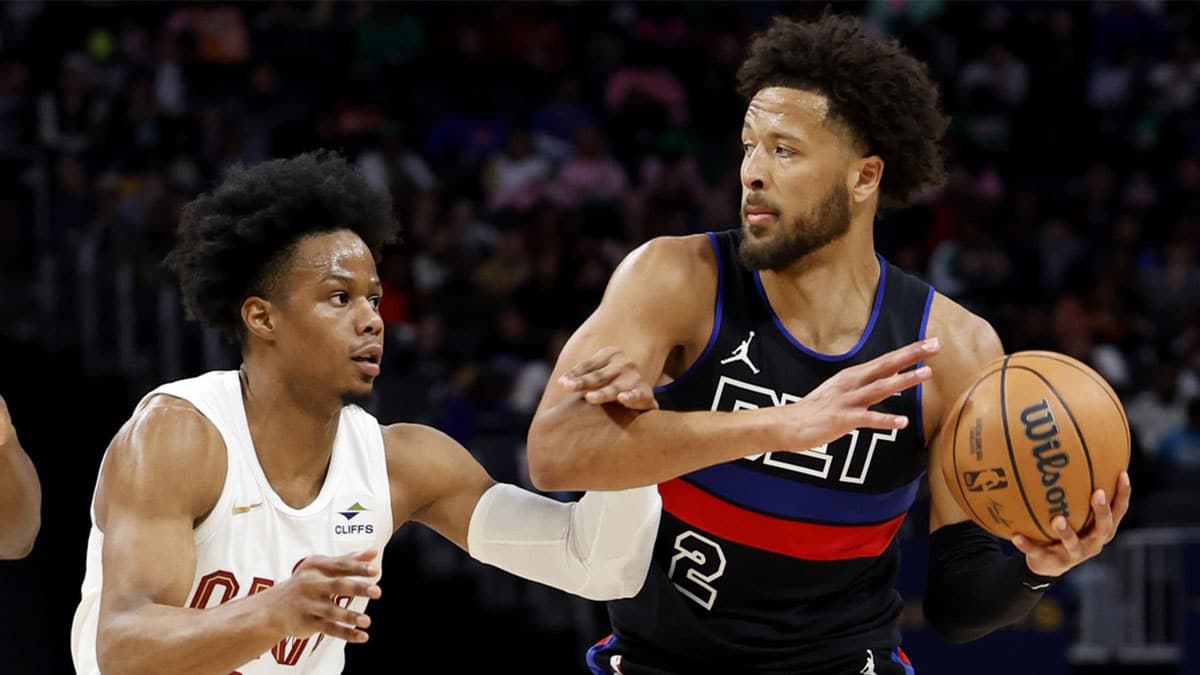 Detroit Pistons guard Cade Cunningham (2) dribbles defended by Cleveland Cavaliers forward Isaac Okoro
