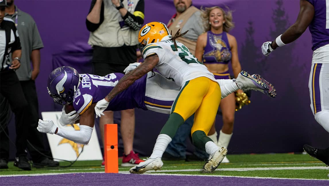 Minnesota Vikings wide receiver Justin Jefferson (18) scores a touchdown on a 36-yard reception while being covered by Green Bay Packers cornerback Eric Stokes (21) during the second quarter of their game Sunday, September 11, 2022 at U.S. Bank Stadium in Minneapolis, Minn.