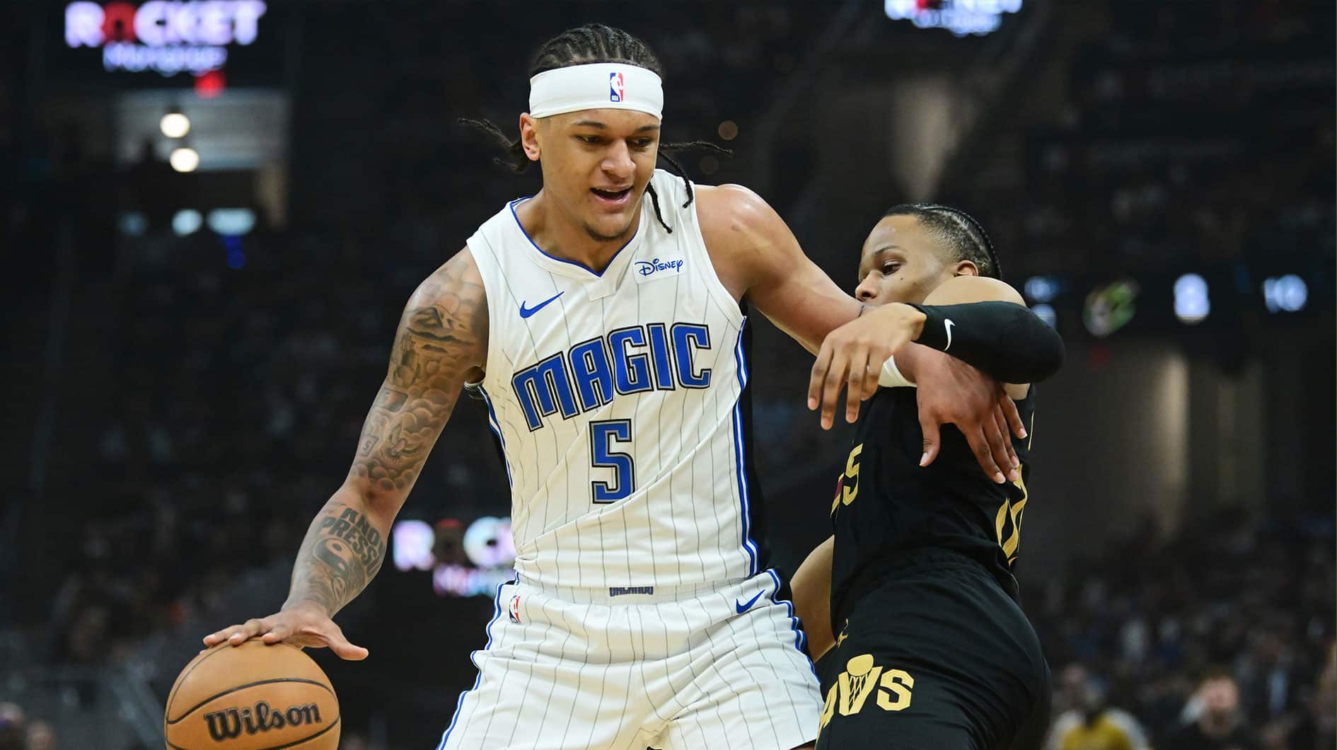 Orlando Magic forward Paolo Banchero (5) drives to the basket against Cleveland Cavaliers forward Isaac Okoro (35) during the first quarter of game seven of the first round for the 2024 NBA playoffs at Rocket Mortgage FieldHouse