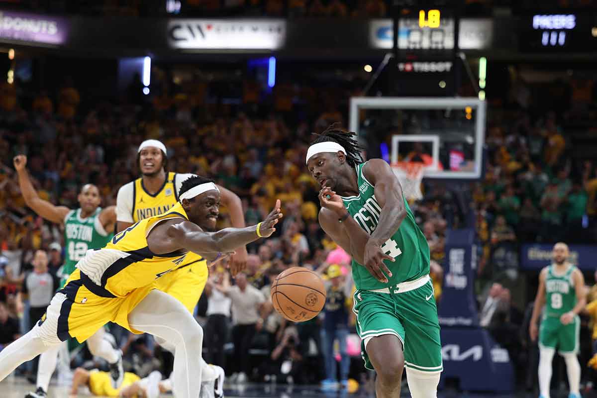Boston Celtics guard Jrue Holiday (4) chases a loose ball against Indiana Pacers forward Pascal Siakam (43) with 1.8 seconds left in game three of the eastern conference finals in the 2024 NBA playoffs at Gainbridge Fieldhouse.