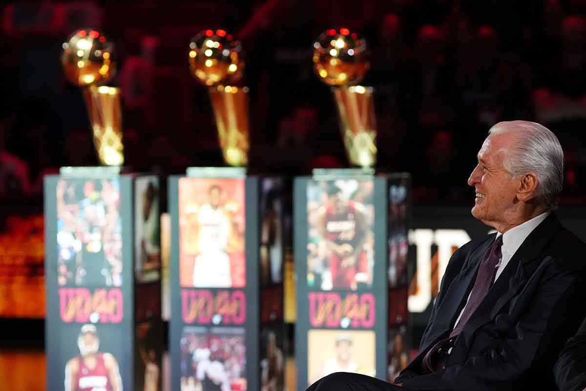 Miami Heat president Pat Riley sits on the court for the jersey retirement ceremony for former player Udonis Haslem during halftime of the game between the Miami Heat and the Atlanta Hawks Kaseya Center.