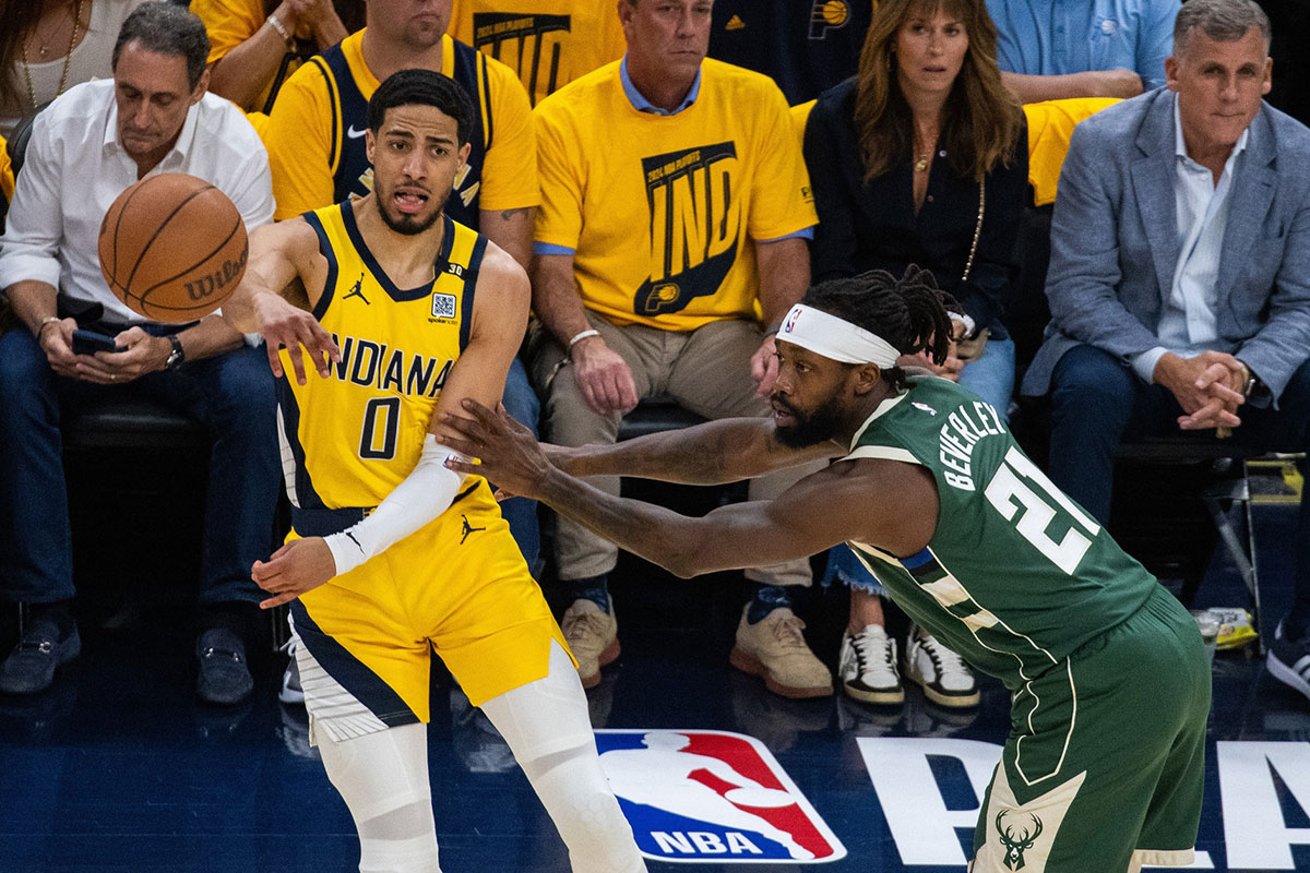 Indiana Pacers guard Tyrese Haliburton (0) passes the ball while Milwaukee Bucks guard Patrick Beverley (21) defends during game six of the first round for the 2024 NBA playoffs at Gainbridge Fieldhouse. 