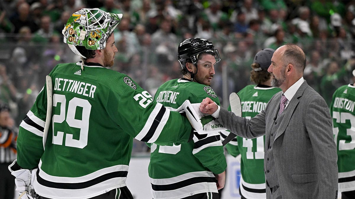 Dallas Stars head coach Peter DeBoer gives a fist bump to goaltender Jake Oettinger (29) after the Stars defeat the Vegas Golden Knights in game seven of the first round of the 2024 Stanley Cup Playoffs at American Airlines Center.