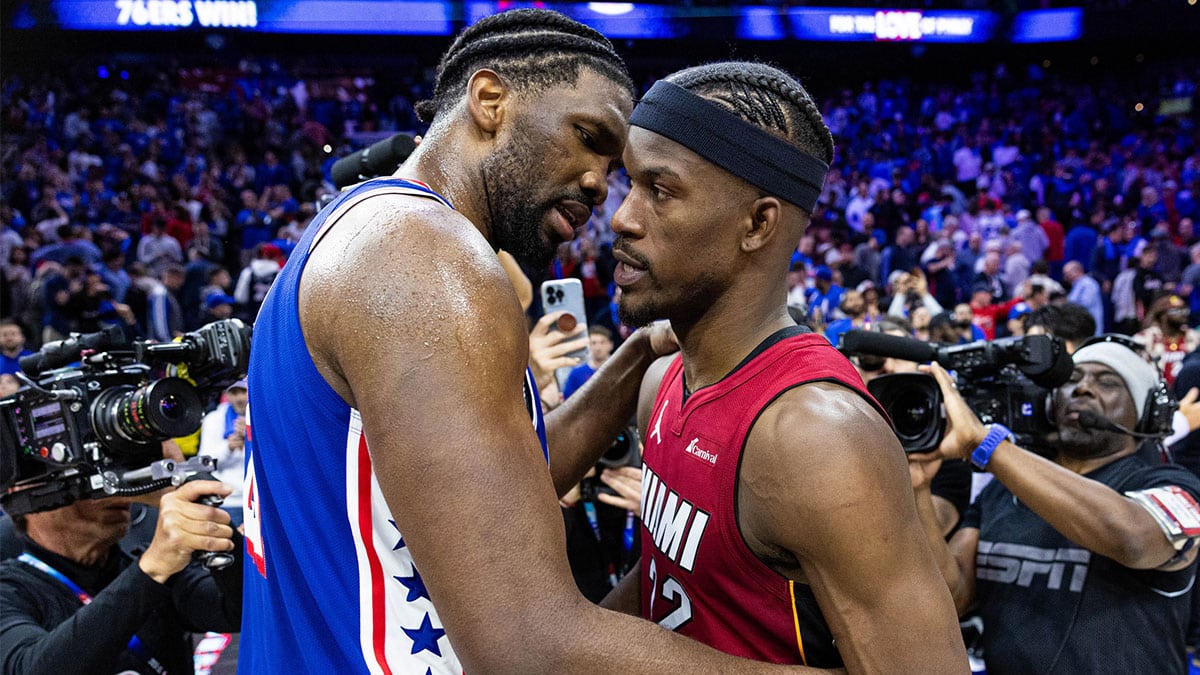 Apr 17, 2024; Philadelphia, Pennsylvania, USA; Philadelphia 76ers center Joel Embiid (21) hugs Miami Heat forward Jimmy Butler (22) on the court after a 76ers victory in a play-in game of the 2024 NBA playoffs at Wells Fargo Center. Mandatory Credit: Bill Streicher-USA TODAY Sports