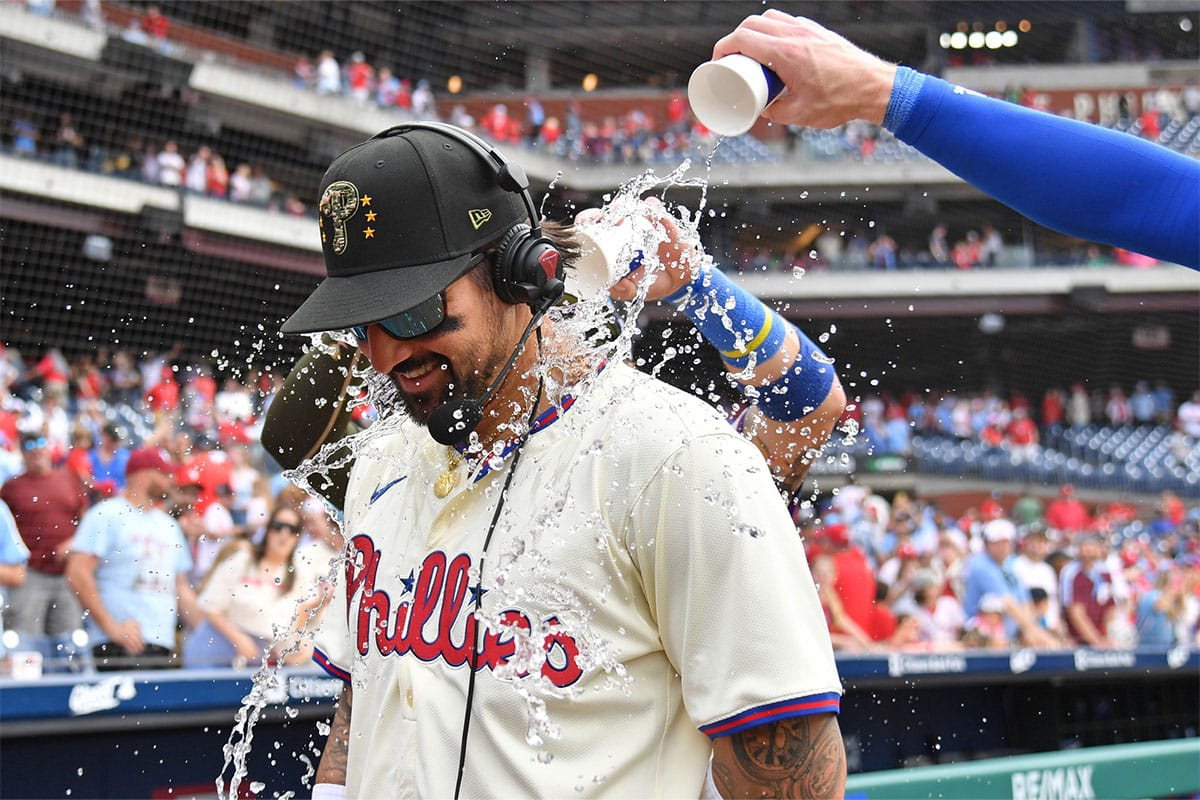 Philadelphia Phillies outfielder Nick Castellanos (8) has water dumped on by teammates after win against the Washington Nationals at Citizens Bank Park. 