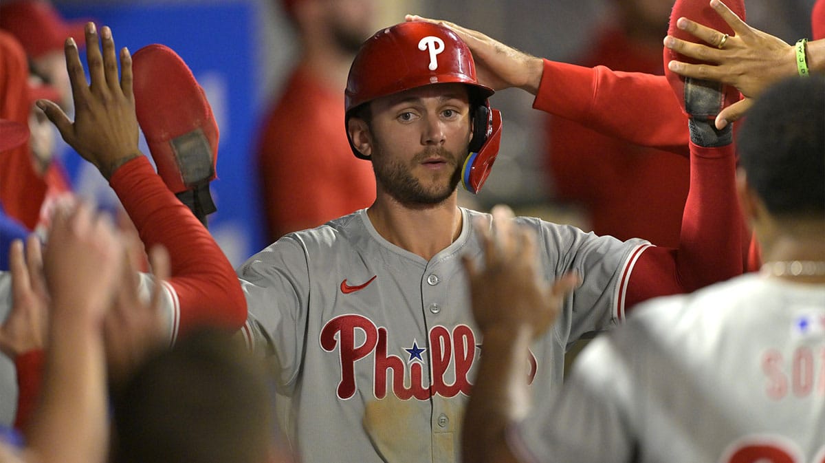 Philadelphia Phillies shortstop Trea Turner (7) is greeted in the dugout after he scored on a sacrifice fly by third baseman Alec Bohm (not pictured) in the ninth inning against the Los Angeles Angels at Angel Stadium.