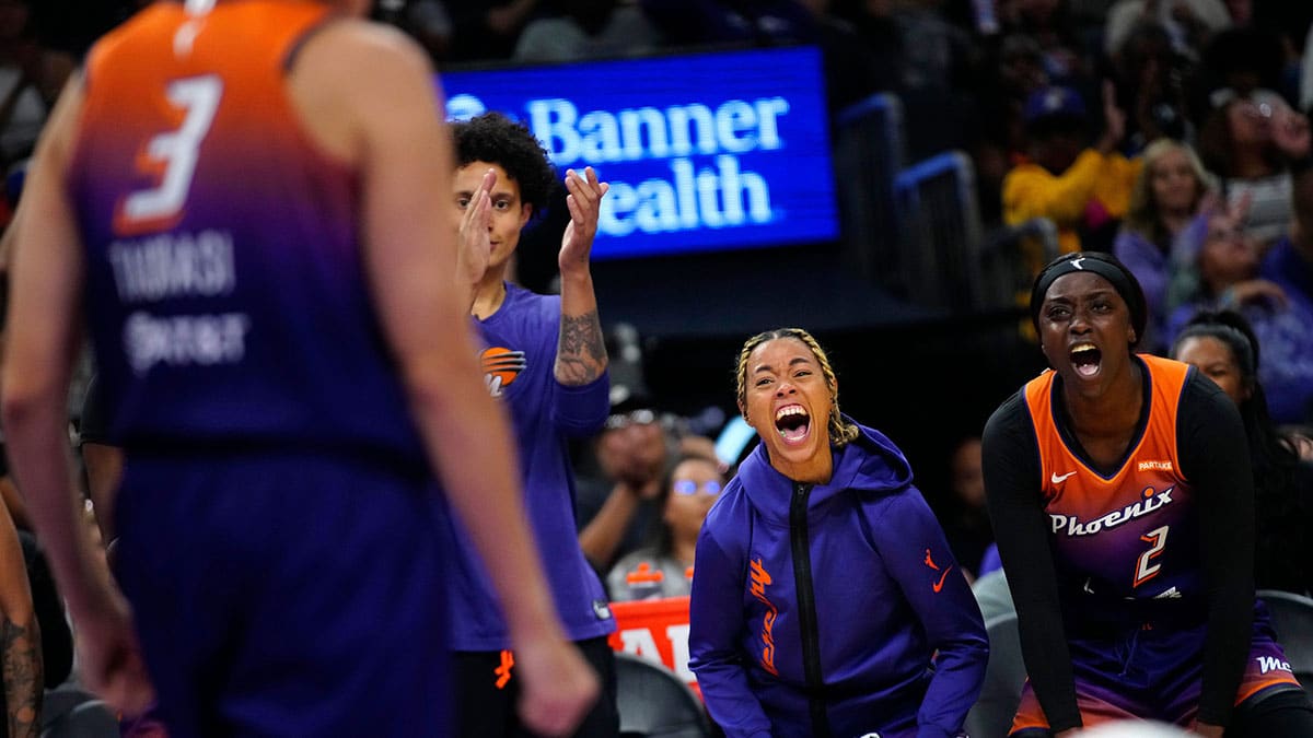 Mercury guards Natasha Cloud (center) and Kahleah Copper (right) celebrate with a scream after a Diana Taurasi basket and a foul against the Dream during the home opener.