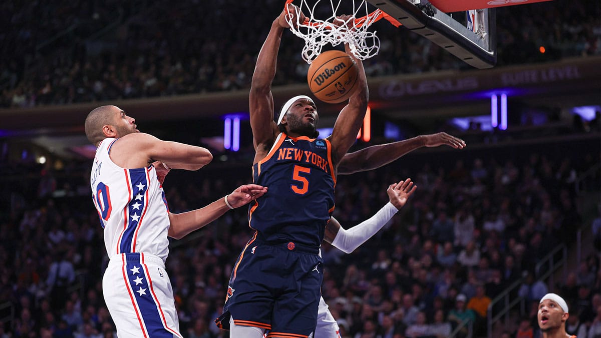 New York Knicks forward Precious Achiuwa (5) dunks the ball in front of Philadelphia 76ers forward Nicolas Batum (40) and forward Paul Reed (44) during the second half at Madison Square Garden. 