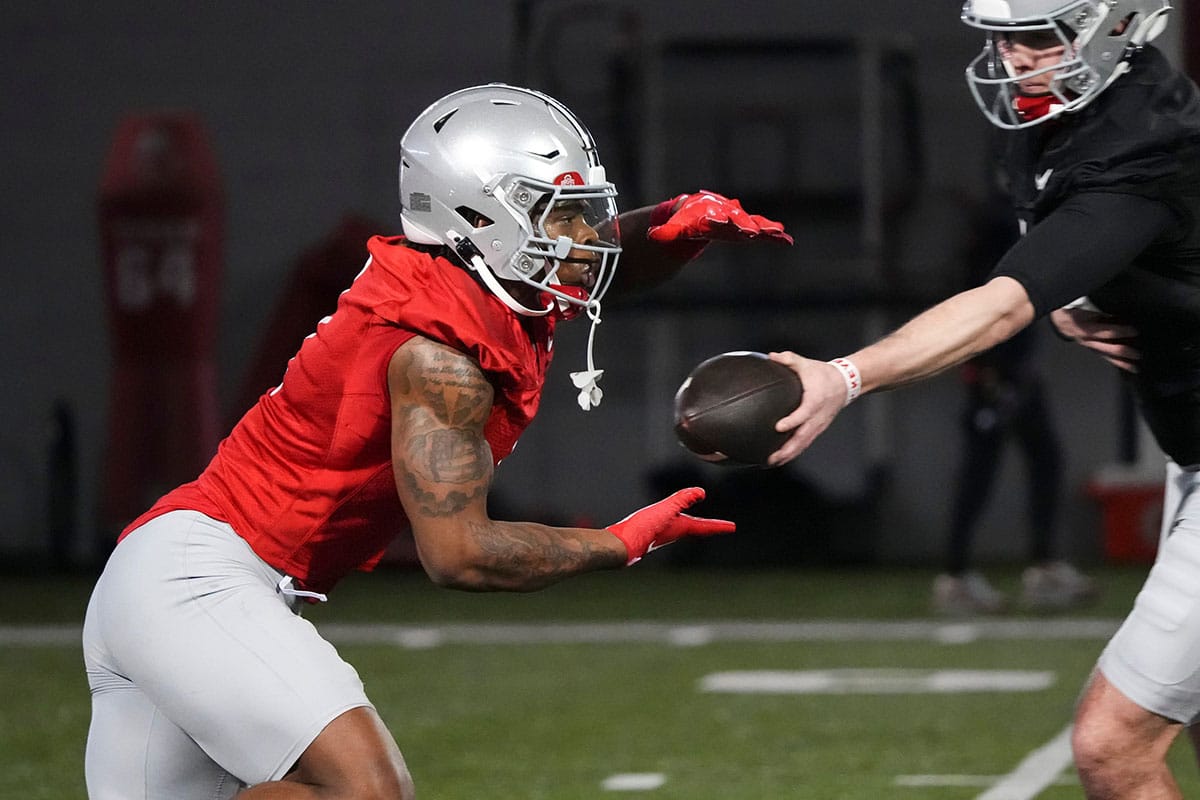 Ohio State Buckeyes running back Quinshon Judkins (1) takes a hand off from quarterback Will Howard (18) during spring football practice at the Woody Hayes Athletic Center.