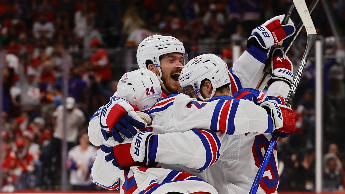 New York Rangers center Alex Wennberg (91) celebrates with center Jack Roslovic (96) and right wing Kaapo Kakko (24) after scoring the game-winning goal in overtime against the Florida Panthers in game three of the Eastern Conference Final of the 2024 Stanley Cup Playoffs at Amerant Bank Arena. 