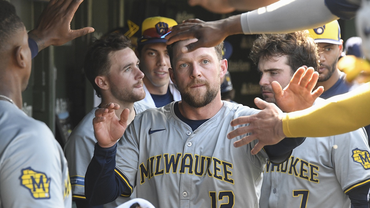 Milwaukee Brewers first base Rhys Hoskins (12) celebrates in the dugout after scoring against the Chicago Cubs during the seventh inning at Wrigley Field.
