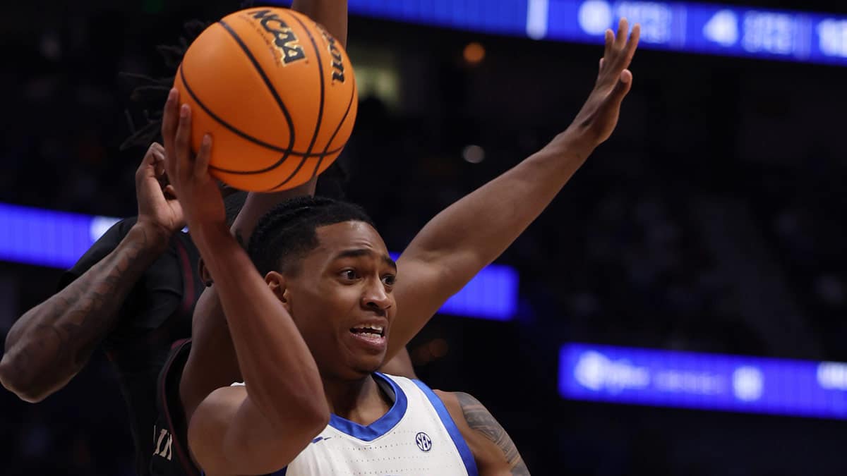 Kentucky Wildcats guard Rob Dillingham (0) looks to pass the ball under pressure during their quarterfinal game against Texas A&M of the SEC Men's Basketball Tournament at Bridgestone Arena in Nashville, Tenn., Friday, March 15, 2024.