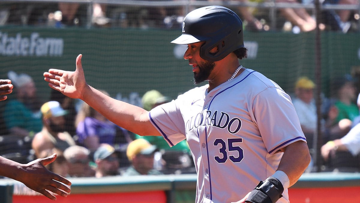 Colorado Rockies catcher Elias Diaz (35) celebrates after scoring a run against the Oakland Athletics during the eleventh inning at Oakland-Alameda County Coliseum. 