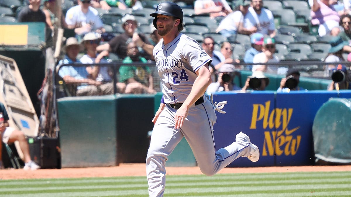  Colorado Rockies third baseman Ryan McMahon (24) scores a run against the Oakland Athletics during the sixth inning at Oakland-Alameda County Coliseum. 