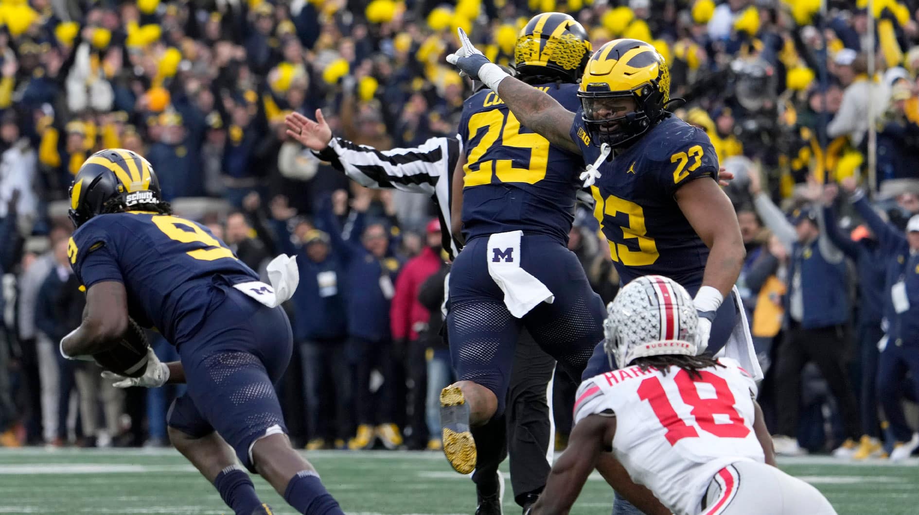 University of Michigan defensive back Rod Moore (9) intercepts a pass intended for Ohio State Buckeyes wide receiver Marvin Harrison Jr. (18) during the second half of Saturday's NCAA Division I football game at Michigan Stadium.