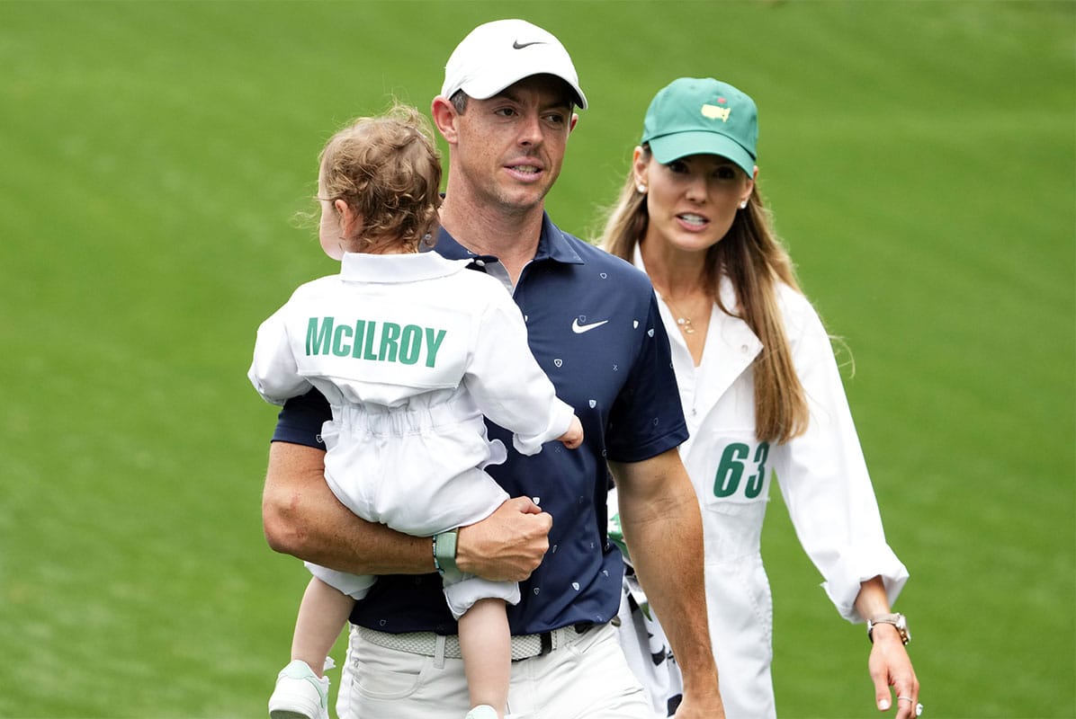 Rory McIlroy holds his daughter Poppy and walks with his wife Erica after finishing the Par 3 Contest at The Masters golf tournament at Augusta National Golf Club.
