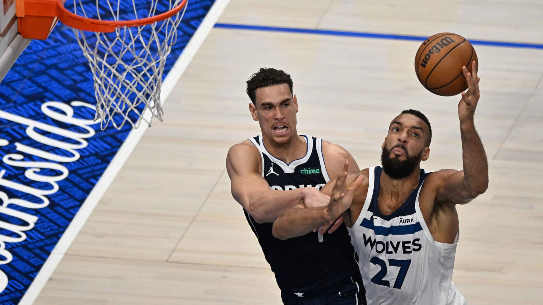 Minnesota Timberwolves center Rudy Gobert (27) collects an offensive rebound over Dallas Mavericks center Dwight Powell (7) during the first quarter of game four of the western conference finals for the 2024 NBA playoffs at American Airlines Center.