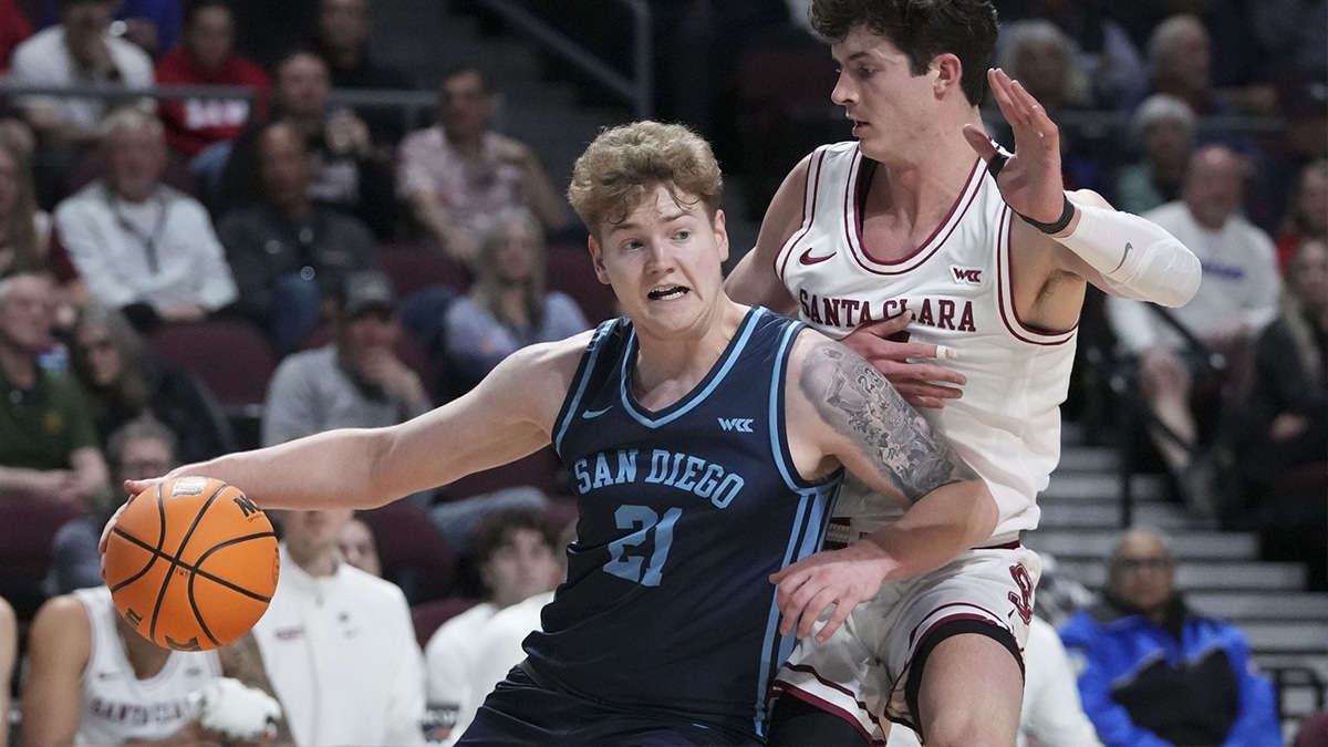  San Diego Toreros forward PJ Hayes (21) dribbles the basketball against Santa Clara Broncos forward Johnny O'Neil (14) during the first half in the quarterfinals of the WCC Basketball Championship at Orleans Arena. 