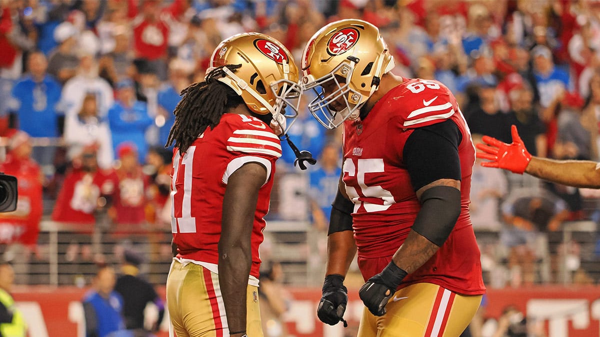 San Francisco 49ers wide receiver Brandon Aiyuk (11) celebrates with guard Aaron Banks (65) after scoring a touchdown against the Detroit Lions