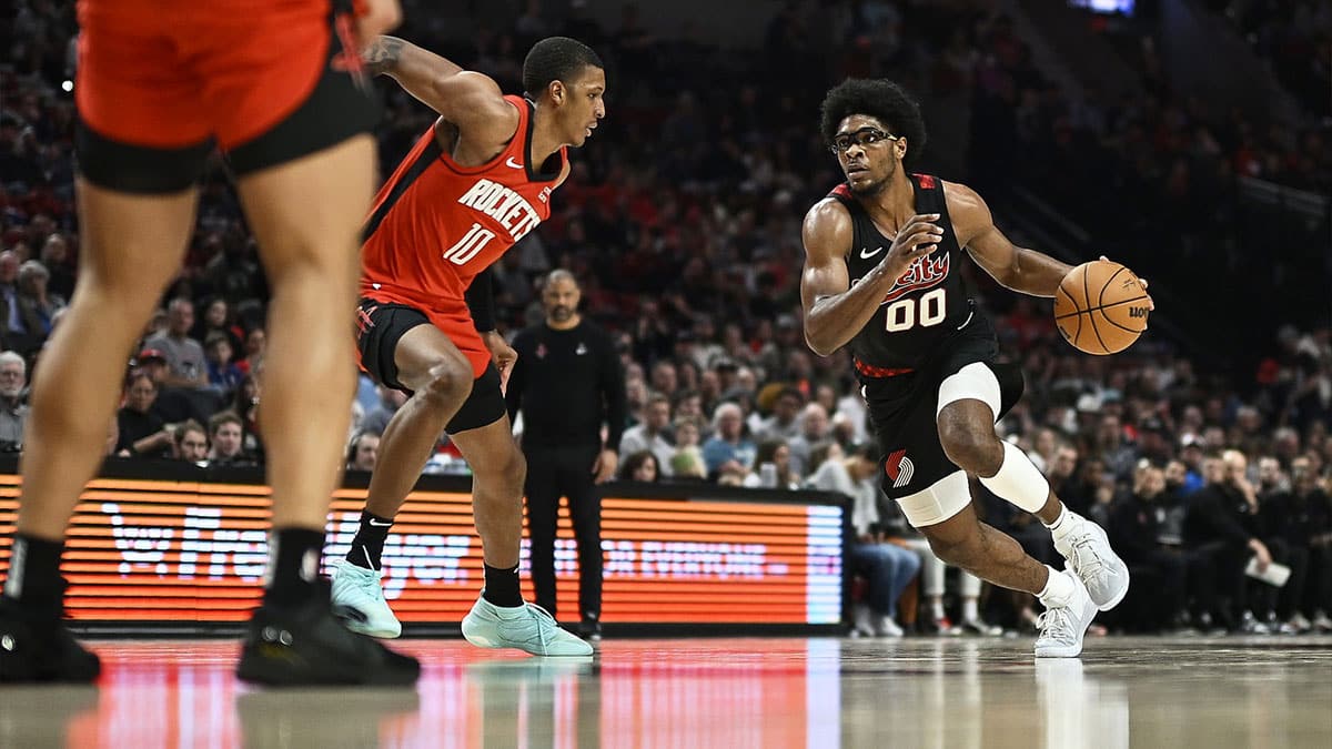Portland Trail Blazers guard Scoot Henderson (00) drives to the basket during the second half against Houston Rockets forward Jabari Smith Jr. (10) at Moda Center.