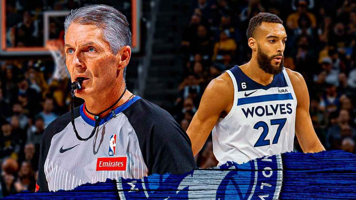 NBA referee Scott Foster stands next to Timberwolves center Rudy Gobert