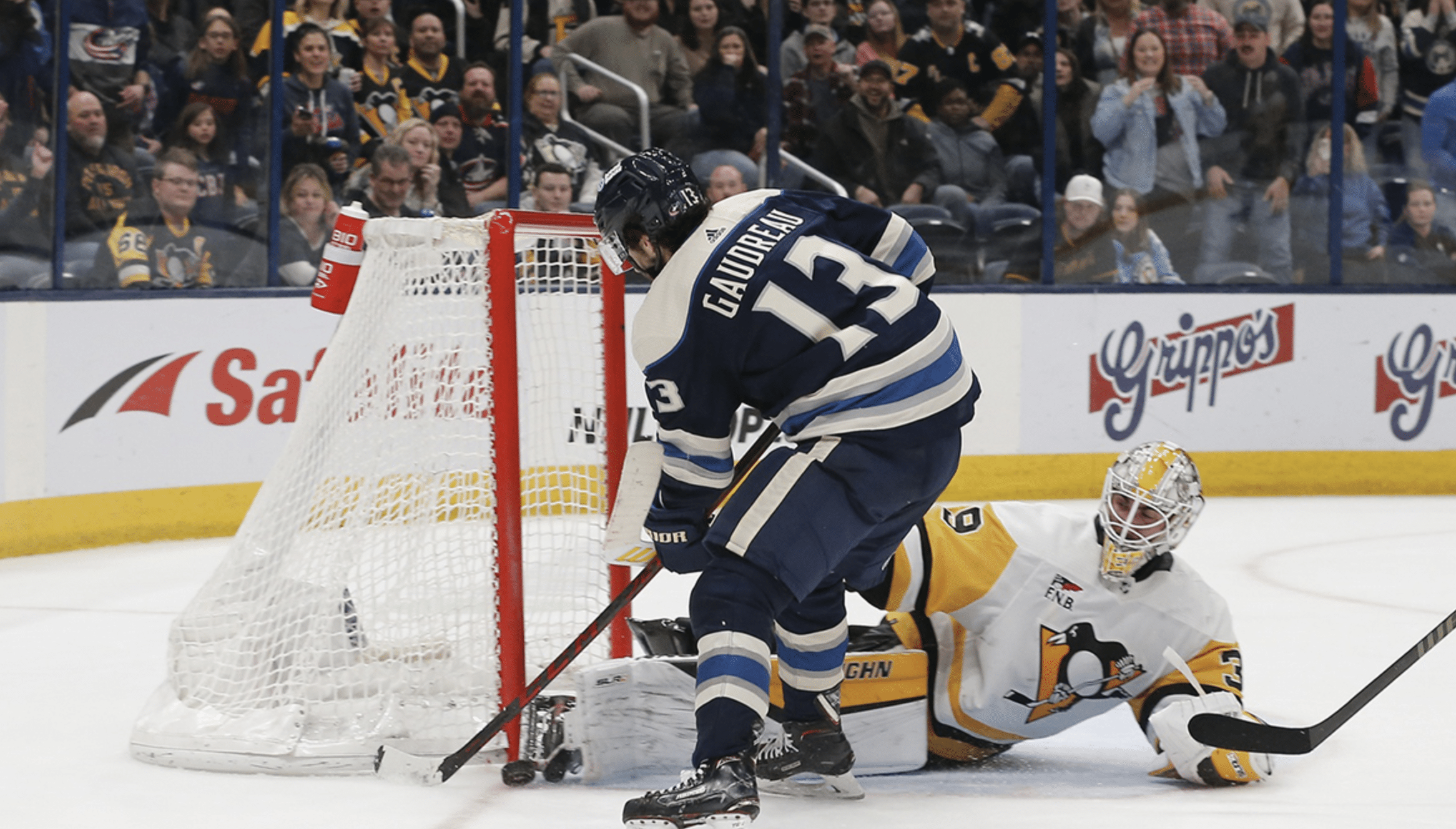 Pittsburgh Penguins goalie Alex Nedeljkovic (39) makes a save on the shot attempt of Columbus Blue Jackets left wing Johnny Gaudreau (13) during overtime at Nationwide Arena