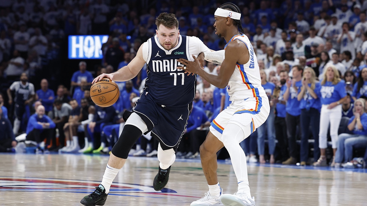 Dallas Mavericks guard Luka Doncic (77) drives to the basket around Oklahoma City Thunder guard Shai Gilgeous-Alexander (2) during the second half of game one of the second round for the 2024 NBA playoffs at Paycom Center.
