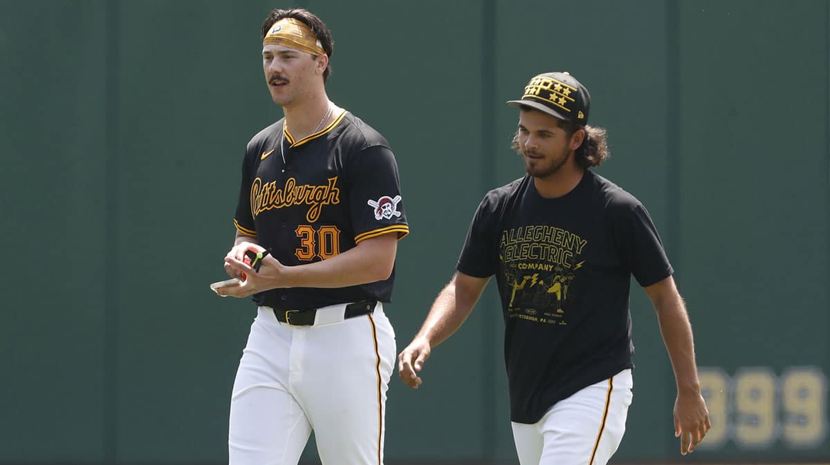 Pittsburgh Pirates pitchers Paul Skenes (left) and Jared Jones (right) walk in the outfield before the game against the Atlanta Braves at PNC Park.