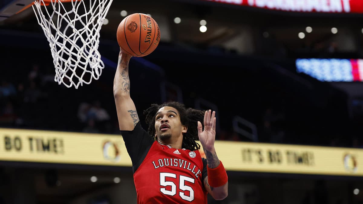 Louisville Cardinals guard Skyy Clark (55) dunks the ball against the North Carolina State Wolfpack in the first half at Capital One Arena. 