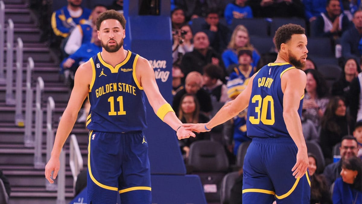 Golden State Warriors shooting guard Klay Thompson (11) and point guard Stephen Curry (30) high five after Thompson scored with an assist from Curry during the first quarter against the Chicago Bulls at Chase Center.
