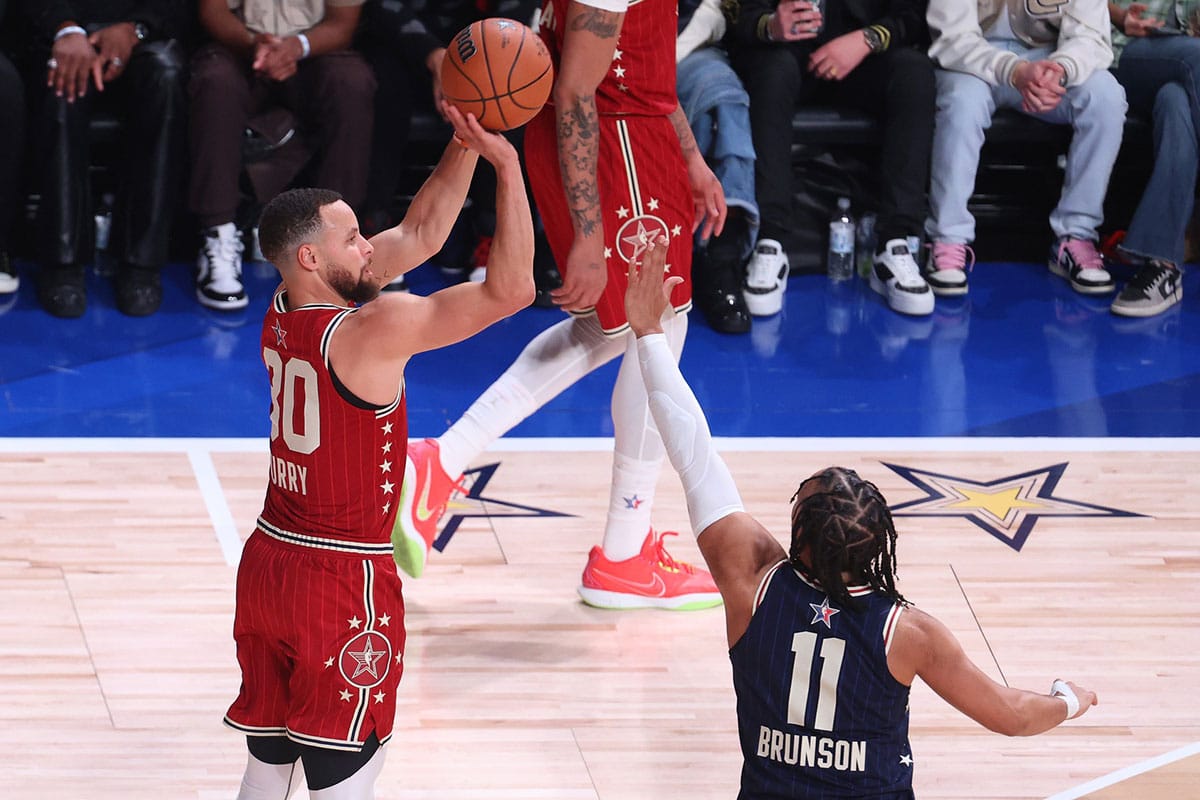 Western Conference guard Stephen Curry (30) of the Golden State Warriors shoots the ball against Eastern Conference guard Jalen Brunson (11) of the New York Knicks during the fourth quarter in the 73rd NBA All Star game at Gainbridge Fieldhouse