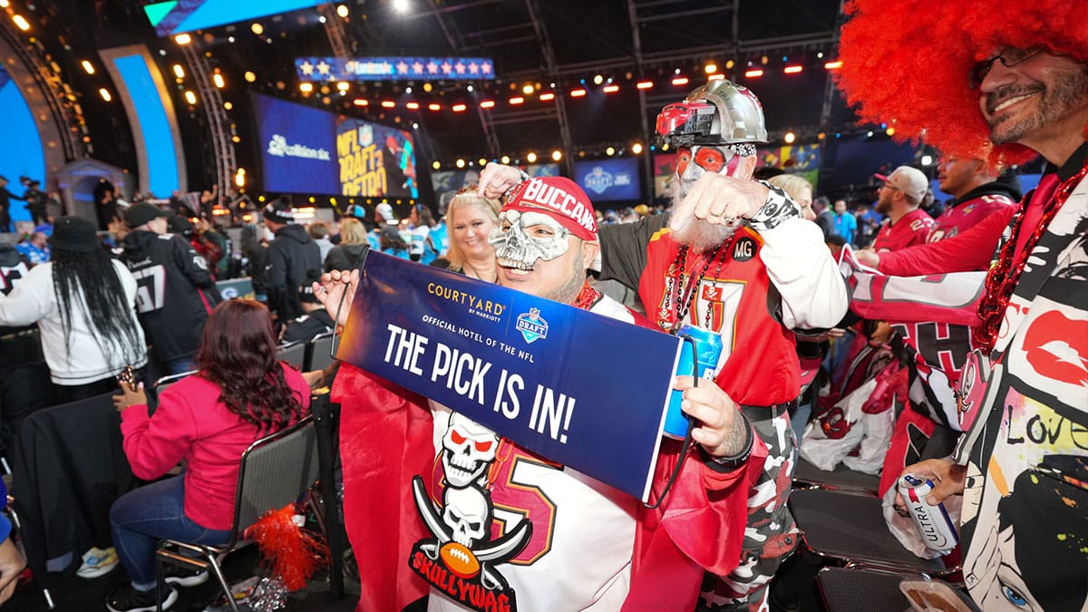 Tampa Bay Buccaneers fans pose for a photograph during the 2024 NFL Draft at Campus Martius Park and Hart Plaza.