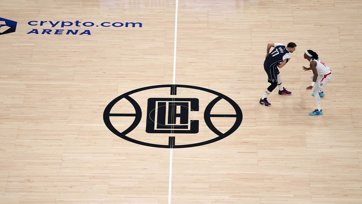 A general overall view as Dallas Mavericks guard Luka Doncic (77) is defended by LA Clippers guard Terance Mann (14) near the Clippers logo at midcourt in the first half during game five of the first round for the 2024 NBA playoffs at Crypto.com Arena. 